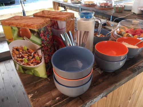 a table with bowls and other food items on it at Anissaras Beach Appartement in Hersonissos