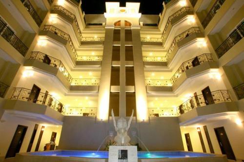 a large building with a statue in front of it at LK Residence in Pattaya Central