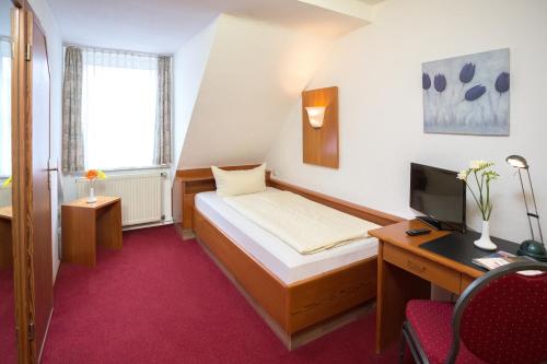 Ένα ή περισσότερα κρεβάτια σε δωμάτιο στο Hotel garni Harzer Hof