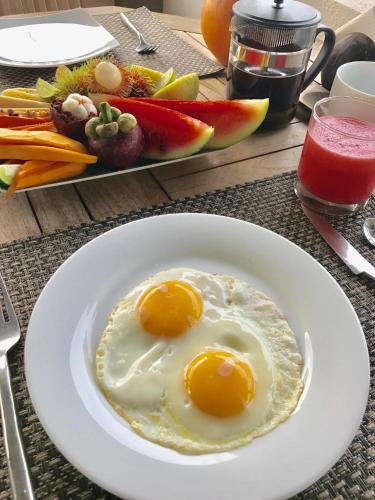 two fried eggs on a white plate on a table at Lara's place in Unawatuna