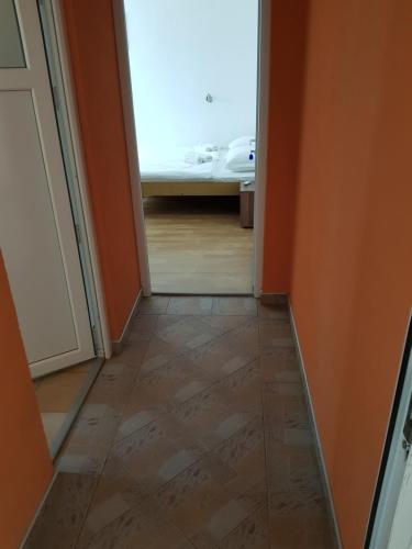 a hallway with a door leading to a room with a bed at Pansion Bojic in Međugorje
