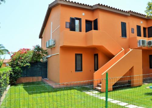 an orange house with an orange staircase at Villetta Amare Sardegna in Costa Rei