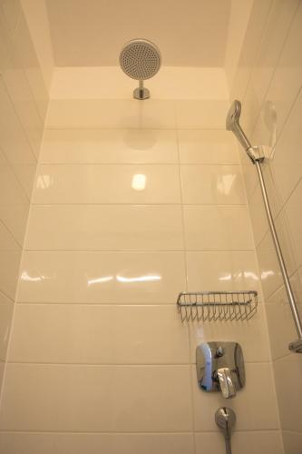 a shower in a bathroom with a shower head at Apartment Villa Franci in Pag