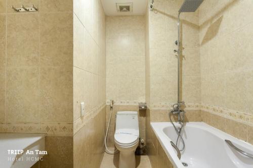 a bathroom with a toilet and a bath tub at Mays Hotel- Ben Thanh in Ho Chi Minh City