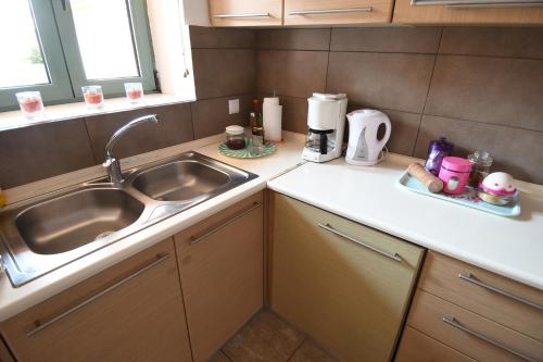 a kitchen with a sink and a counter top at Sofokleous Apartment in Kavála