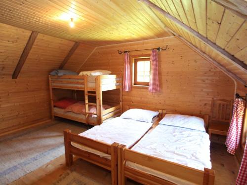 a bedroom with two beds in a log cabin at Chalet in Obervellach Carinthia in Obervellach