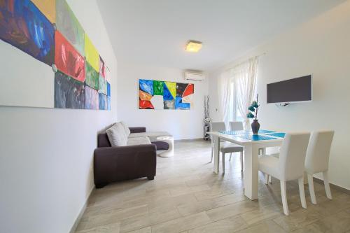 a living room with a table and a couch at Apartments Mali Nono in Krk