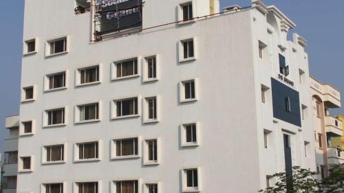 a white building with a sign on the side of it at Hotel Southern Grand in Vijayawāda