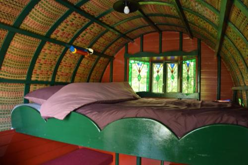 a large bed in a room with a window at De huifkar in Warstiens