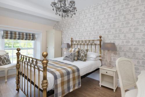 a bedroom with a bed and a brick wall at The King's Head in Thirlmere