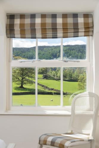 a window with a view of a golf course at The King's Head in Thirlmere
