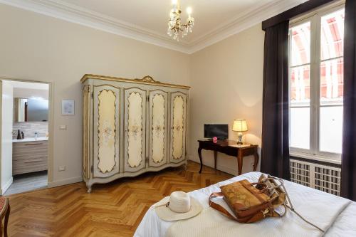 a bedroom with a large bed and a large cabinet at Hotel Villa Maria in Sanremo