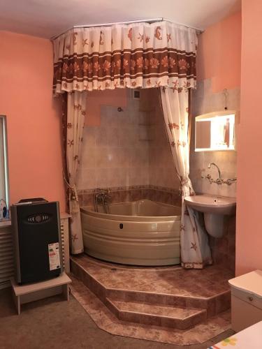 a bathroom with a tub and a sink at Jackie House Varna in Varna City