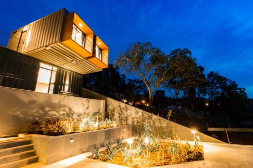 a house with lights on the side of it at Zostel Plus Panchgani in Panchgani