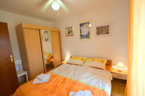 Postel nebo postele na pokoji v ubytování Apartments Neven