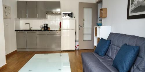 a living room with a couch and a kitchen at Nice Seaview Free Parking 4.Pers in Nice
