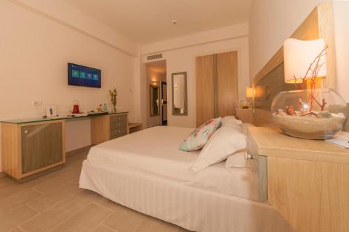 a hotel room with a large bed and a kitchen at Summit Hotel in Gaeta