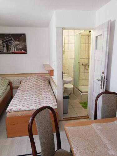 a small room with a bed and a bathroom at Camping Mauritius in Mielno
