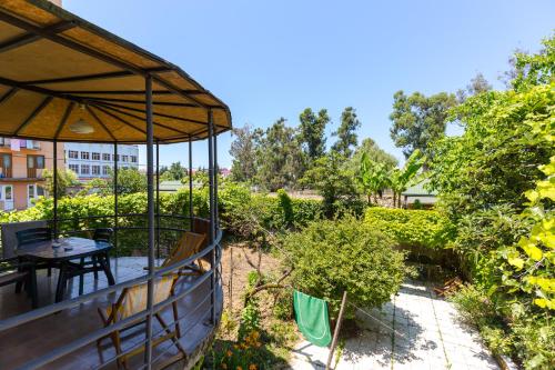 a patio with a table and an umbrella at Samno Guest House in Batumi