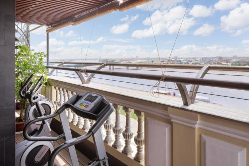 a balcony with a treadmill and a view of the water at LCS Hotel & Apartment in Phnom Penh
