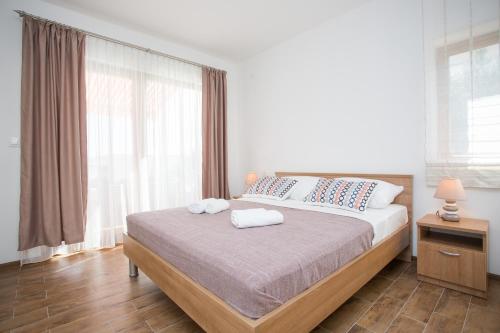 a bedroom with a bed with two towels on it at Losko in Solin