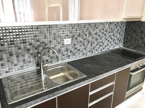 a kitchen with a sink and a counter top at EKA Luxury Penthouse in Durrës