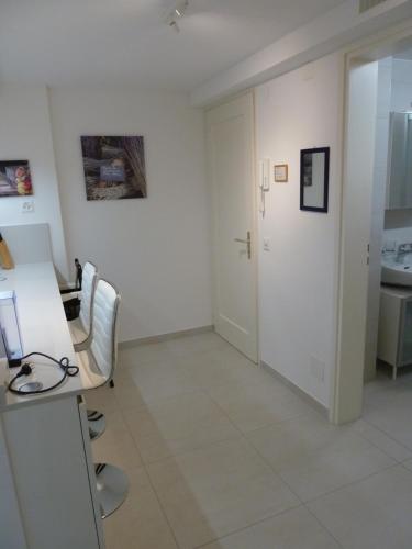 a white room with a desk and a sink at New "Casa Maria" in Ascona