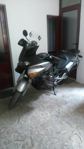 a motorcycle parked in a room next to a door at Apartments & Hostel Zdrava Hrana in Mostar