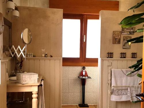 a bathroom with a sink and a mirror and a window at Casa Bonita Navacerrada in Navacerrada