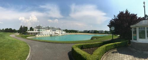 a large house with a lake in front of it at Hotel Landhaus Moserhof in Gumpoldskirchen