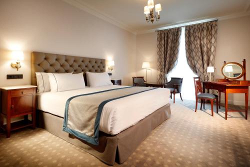 a hotel room with a large bed and a desk at Eurostars Hotel Real in Santander