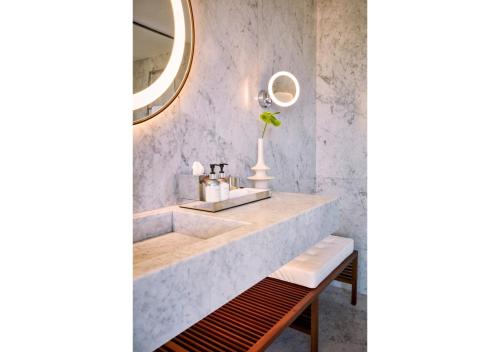 a white sink sitting under a mirror in a bathroom at Sir Joan Hotel in Ibiza Town