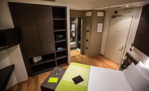 a living room with a room with a table and a room with a door at Best Western Plus The Hub Hotel in Milan