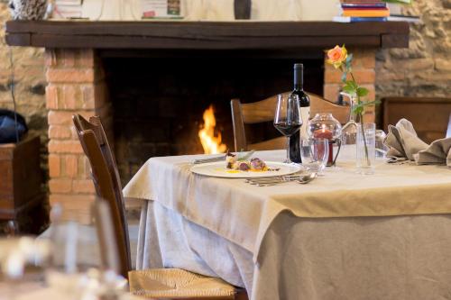 a table with a plate of food and a bottle of wine at La Rosa Nel Bicchiere in Soveria Mannelli
