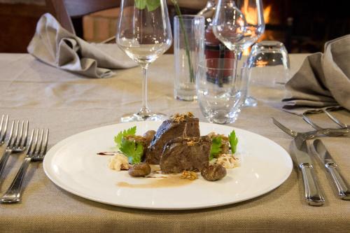 a plate of food on a table with wine glasses at La Rosa Nel Bicchiere in Soveria Mannelli