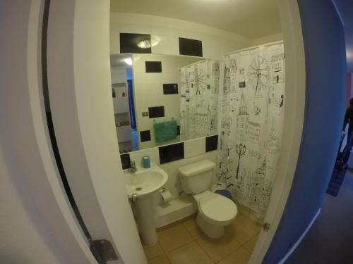a bathroom with a toilet and a sink at Departamento Amoblado Seminario in Talca