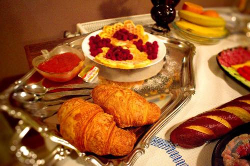 a tray of pastries and other food on a table at Marilyn Apartments in Smederevo
