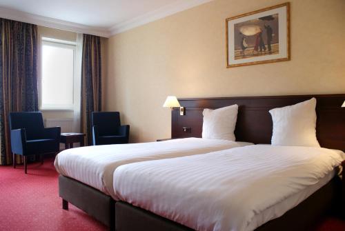 En eller flere senge i et værelse på Fletcher Hotel-Restaurant de Dikke van Dale