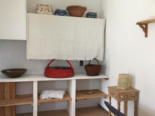 a shelf with baskets on top of it in a room at Hôtel Lido Beach in Hyères