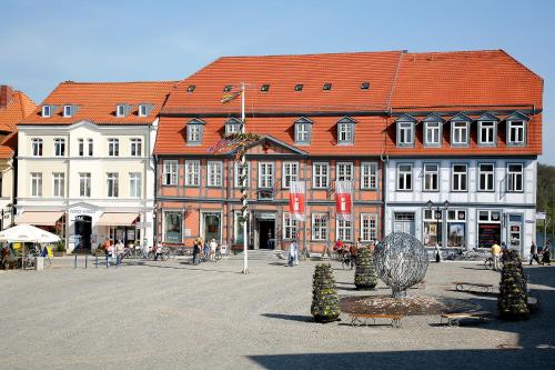 a large building with red roofs in a town square at Ferienresidenz "Seelust" Whg 5 in Waren
