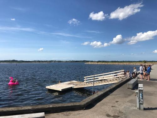 a dock with a pink float in the water at Villa Wiegand - a room with a view in Holbæk