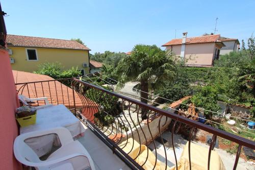 a balcony with a view of a house at Apartment Mihaela in Rovinj