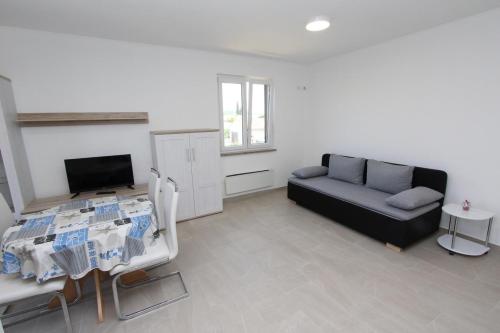a living room with a couch and a table at Apartment Mihaela in Rovinj