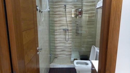 a bathroom with a shower and a toilet at Savannah Beach D11 in Sidi Rahal
