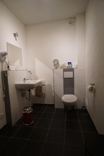 a small bathroom with a sink and a toilet at Gaestehaus Jufferpanorama in Brauneberg