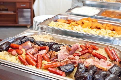 a buffet filled with different types of food in trays at Aparthotel Snjezna Kraljica in Zagreb
