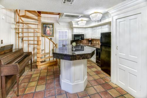 a kitchen with a counter and a refrigerator at Chateau Orleans in New Orleans