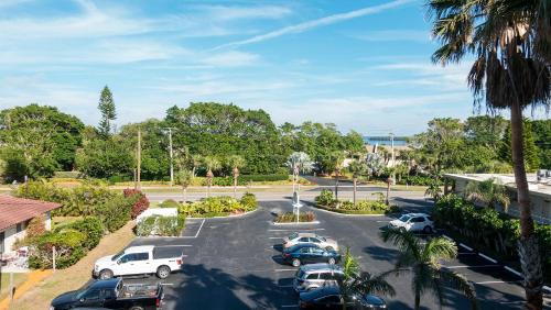 a parking lot with several cars parked in it at Beach and sunset view from your balcony in Longboat Key