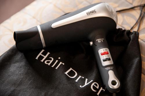 a hair dryer sitting on top of a cloth at Grainger Apartments in Newcastle upon Tyne