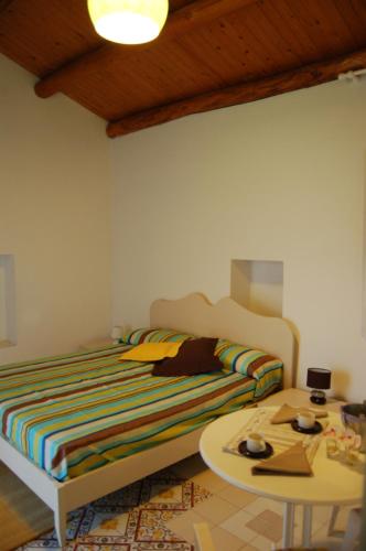 1 dormitorio con cama y mesa de centro en Vecchia Fattoria Case Vacanza al mare, en Belvedere Marittimo